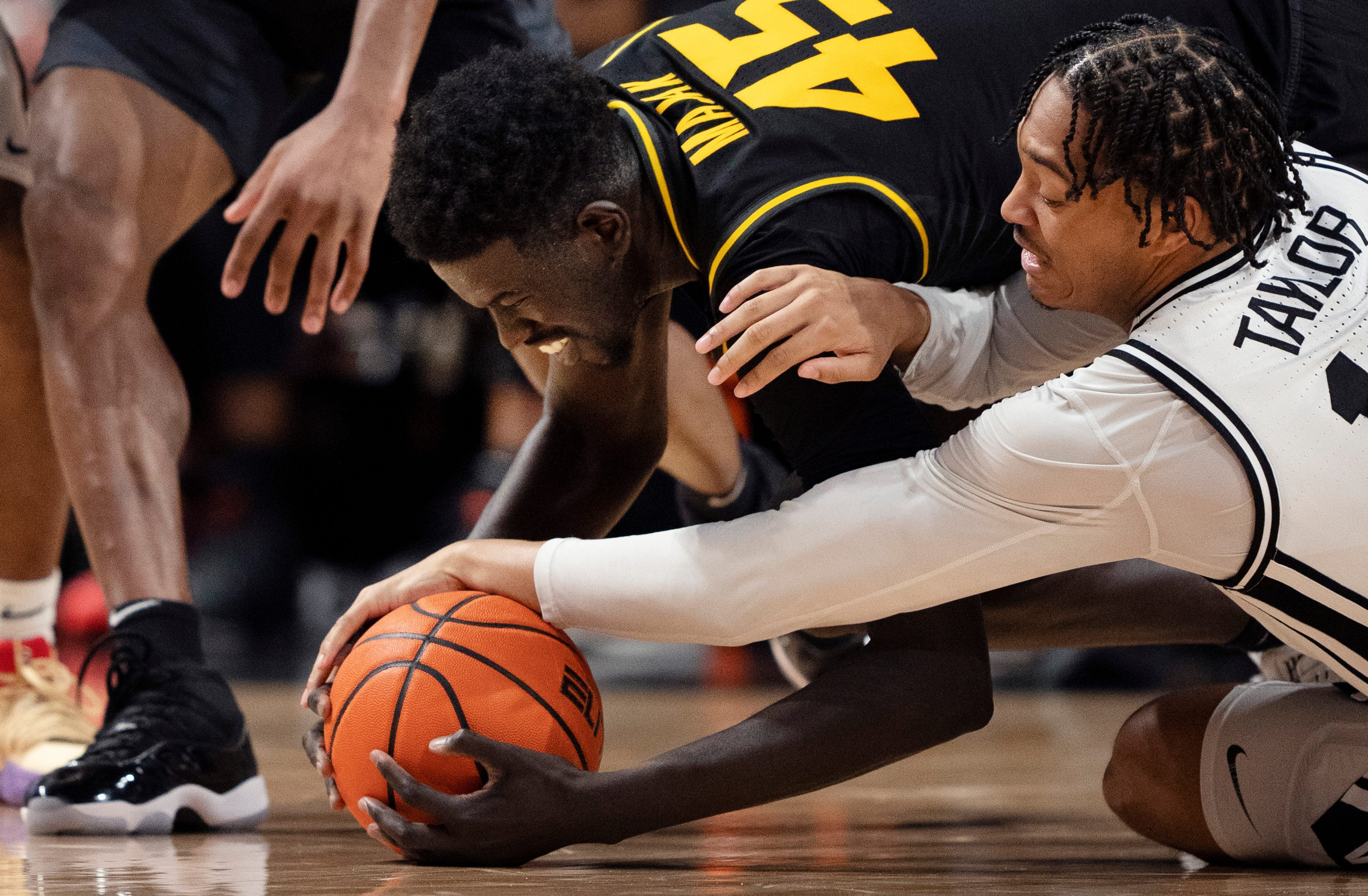 Missouri Tigers center Mabor Majak (45) gets the a long rebound ahead of Vanderbilt Commodores guard Evan Taylor (12) during their game at Memorial Gym in Nashville, Tenn., Saturday, Feb. 3, 2024.
