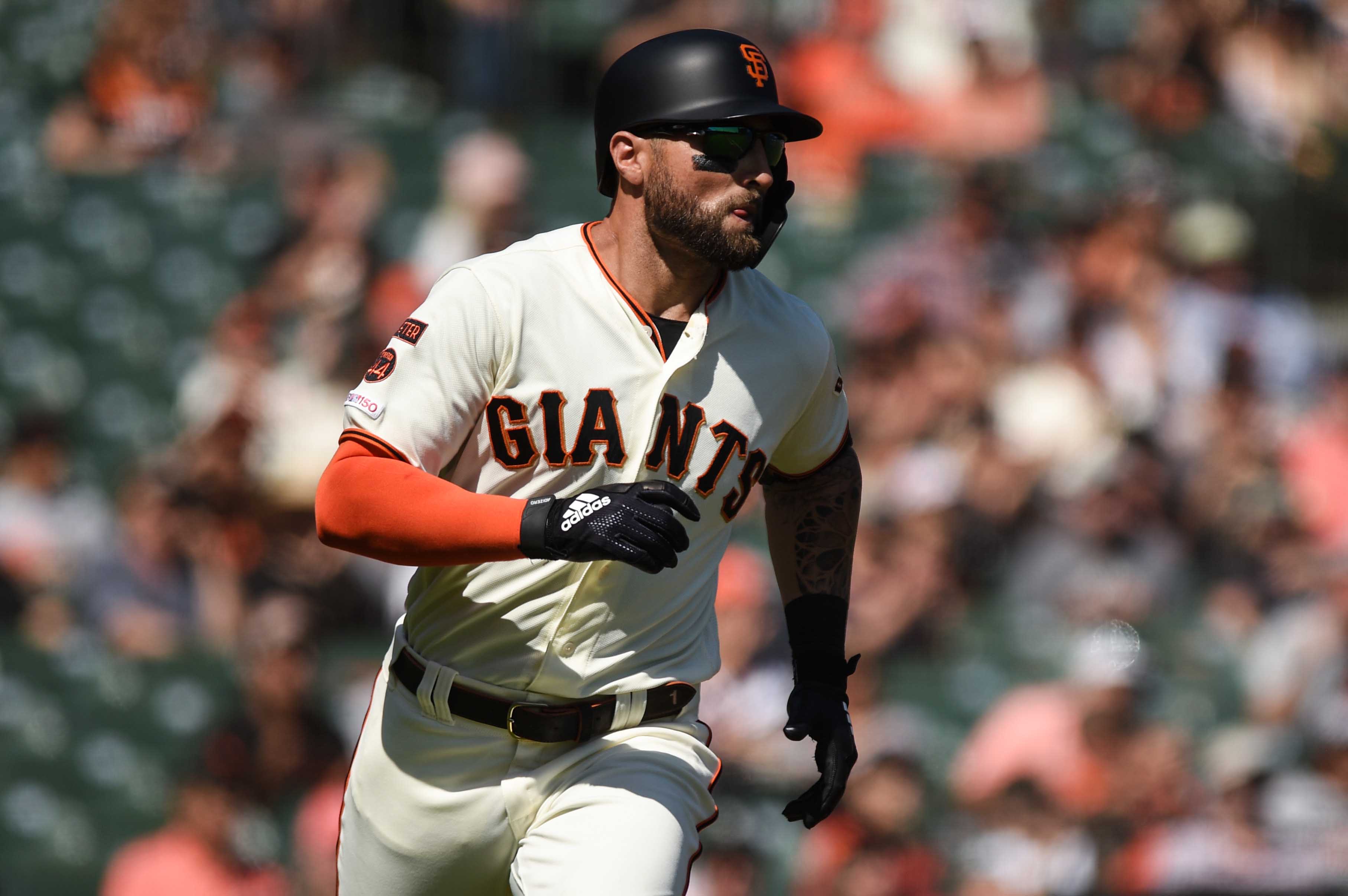 SF Giants center fielder Kevin Pillar runs to first base after hitting an RBI single against the Colorado Rockies in the first inning at Oracle Park. (2019)