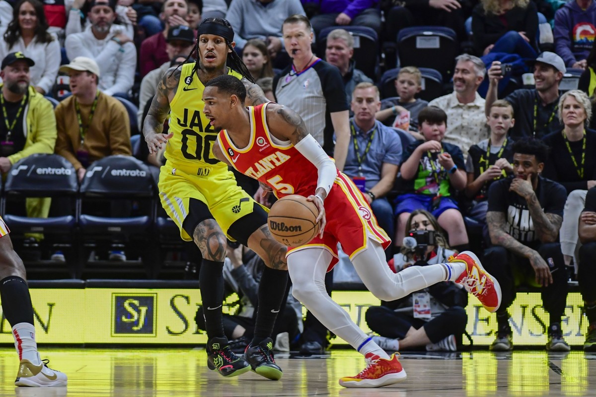 Feb 3, 2023; Salt Lake City, Utah, USA; Atlanta Hawks guard Dejounte Murray (5) dribbles around Utah Jazz guard Jordan Clarkson (00) during the second half at Vivint Arena.