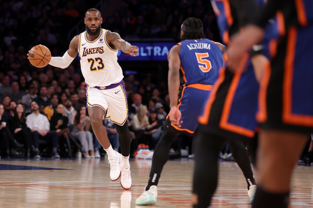 Feb 3, 2024; New York, New York, USA; Los Angeles Lakers forward LeBron James (23) brings the ball up court against New York Knicks forward Precious Achiuwa (5) during the second quarter at Madison Square Garden.