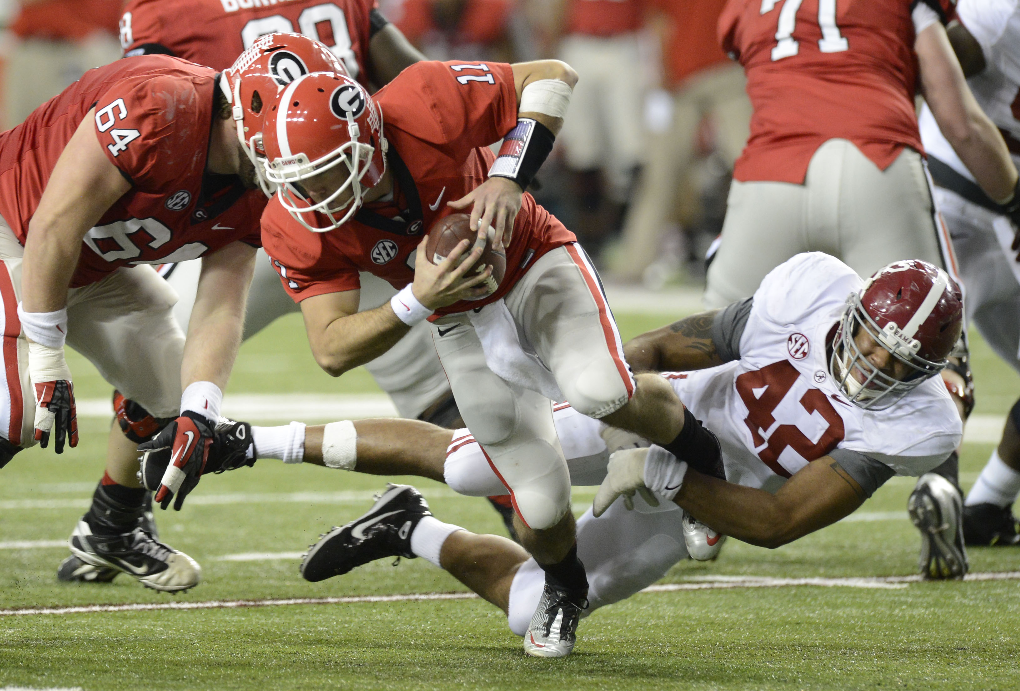 Dec 1, 2012; Atlanta, GA, USA; Georgia Bulldogs quarterback Aaron Murray is sacked by Alabama Crimson Tide linebacker Adrian Hubbard during the fourth quarter in the 2012 SEC Championship game at the Georgia Dome.