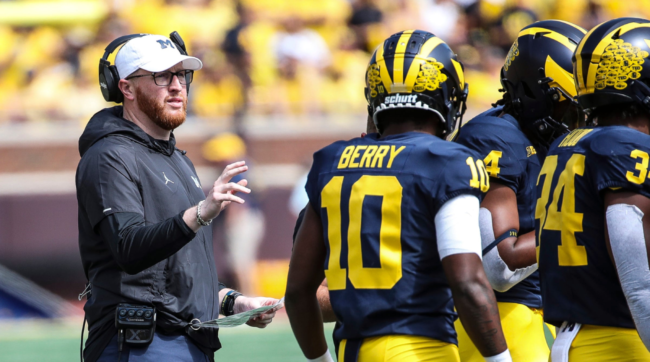 Michigan special teams coach Jay Harbaugh speaks to players.