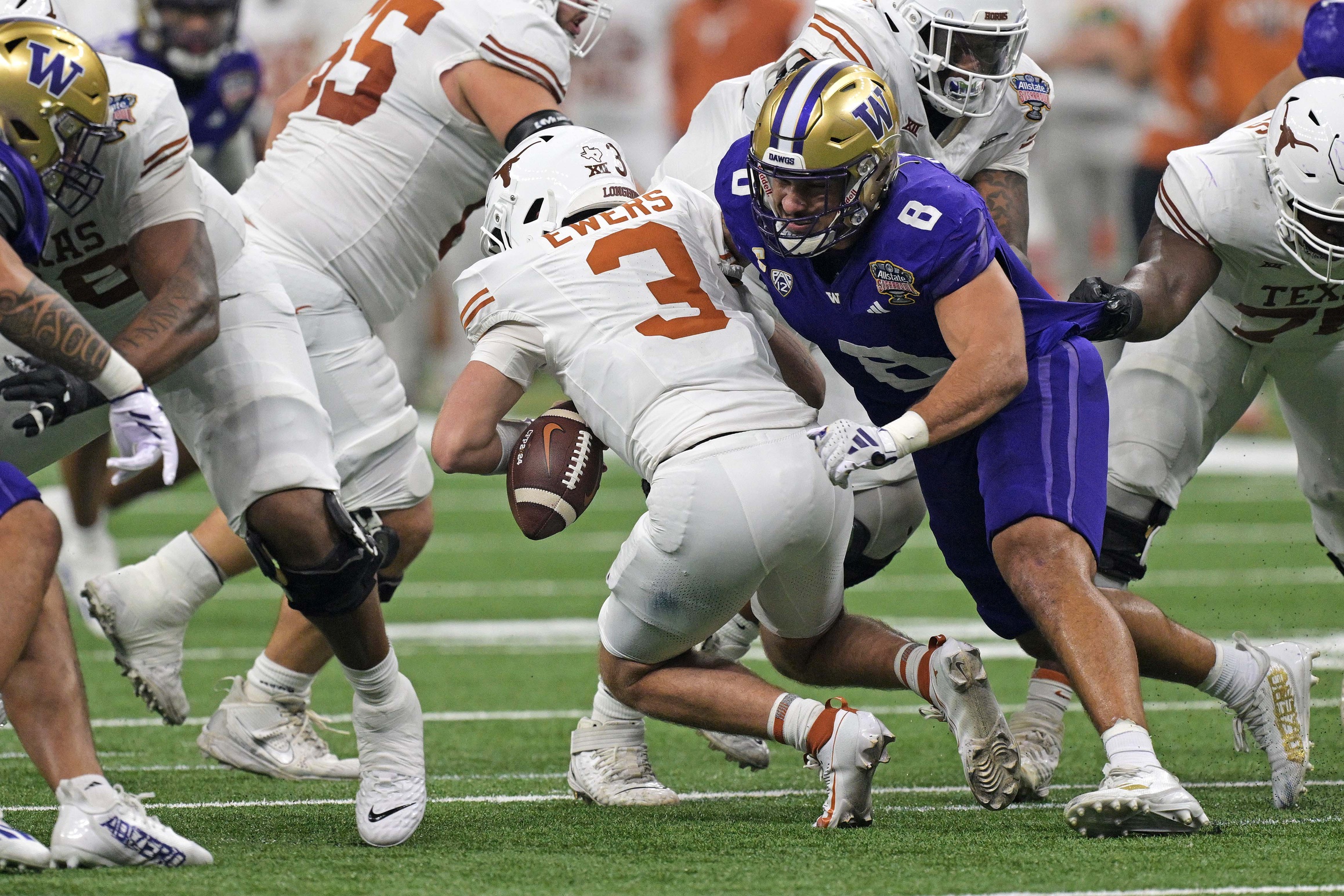 Jan 1, 2024; New Orleans, LA, USA; Washington Huskies defensive end Bralen Trice (8) knocks the ball away from Texas Longhorns quarterback Quinn Ewers (3) during the second quarter in the 2024 Sugar Bowl college football playoff semifinal game at Caesars Superdome.