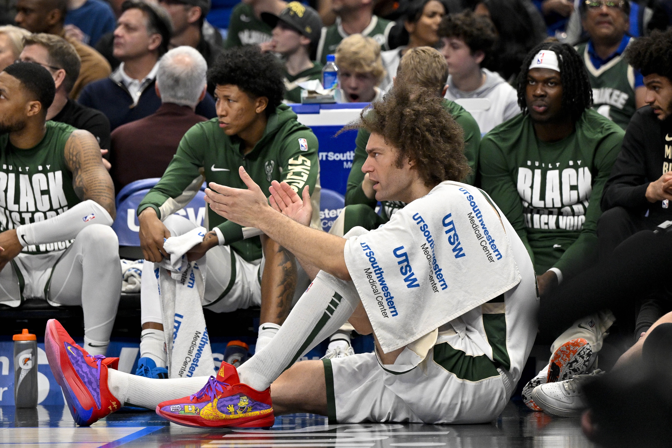 Milwaukee Bucks center Robin Lopez (42) cheers for his team from the bench during the second quarter against the Dallas Mavericks