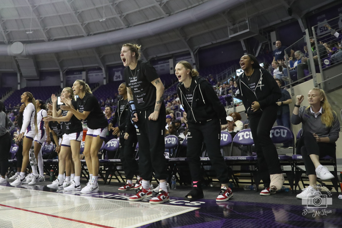 TCU women's basketball bench reacts to a made shot