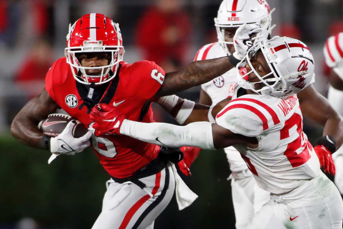 Georgia wide receiver Dominic Lovett (6) stiff arms Ole Miss safety Trey Washington (25) during the first half of an NCAA college football game against Ole Miss in Athens, Ga., on Saturday, Nov. 11, 2023.