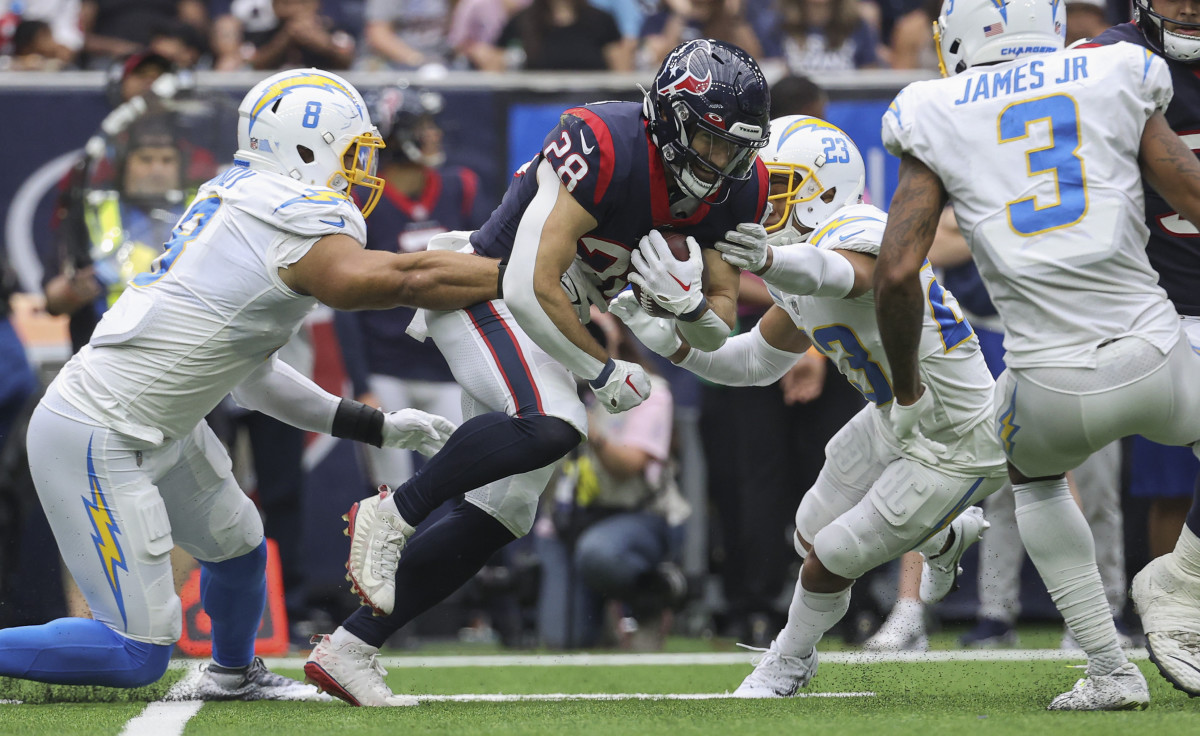 Texans running back Rex Burkhead (28) runs with the ball as Los Angeles Chargers cornerback Bryce Callahan (23) attempts to make a tackle during the fourth quarter at NRG Stadium.