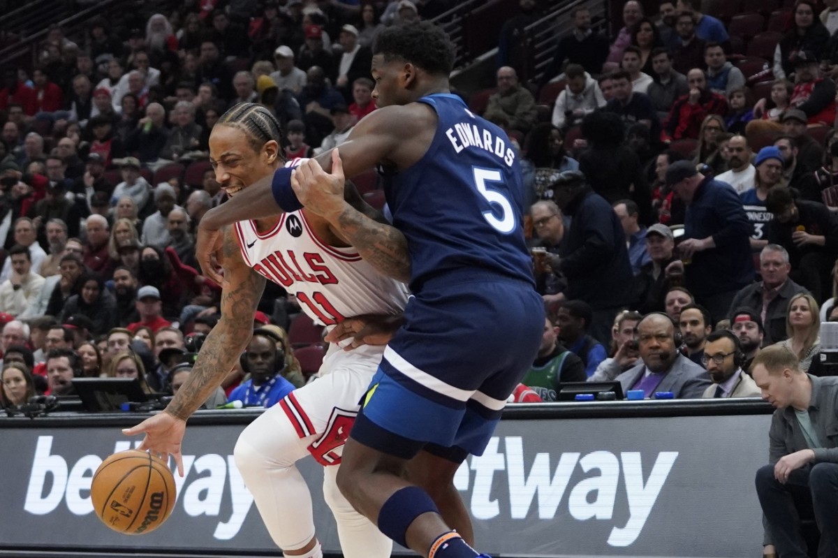 Feb 6, 2024; Chicago, Illinois, USA; Minnesota Timberwolves guard Anthony Edwards (5) defends Chicago Bulls forward DeMar DeRozan (11) during the first quarter at United Center.