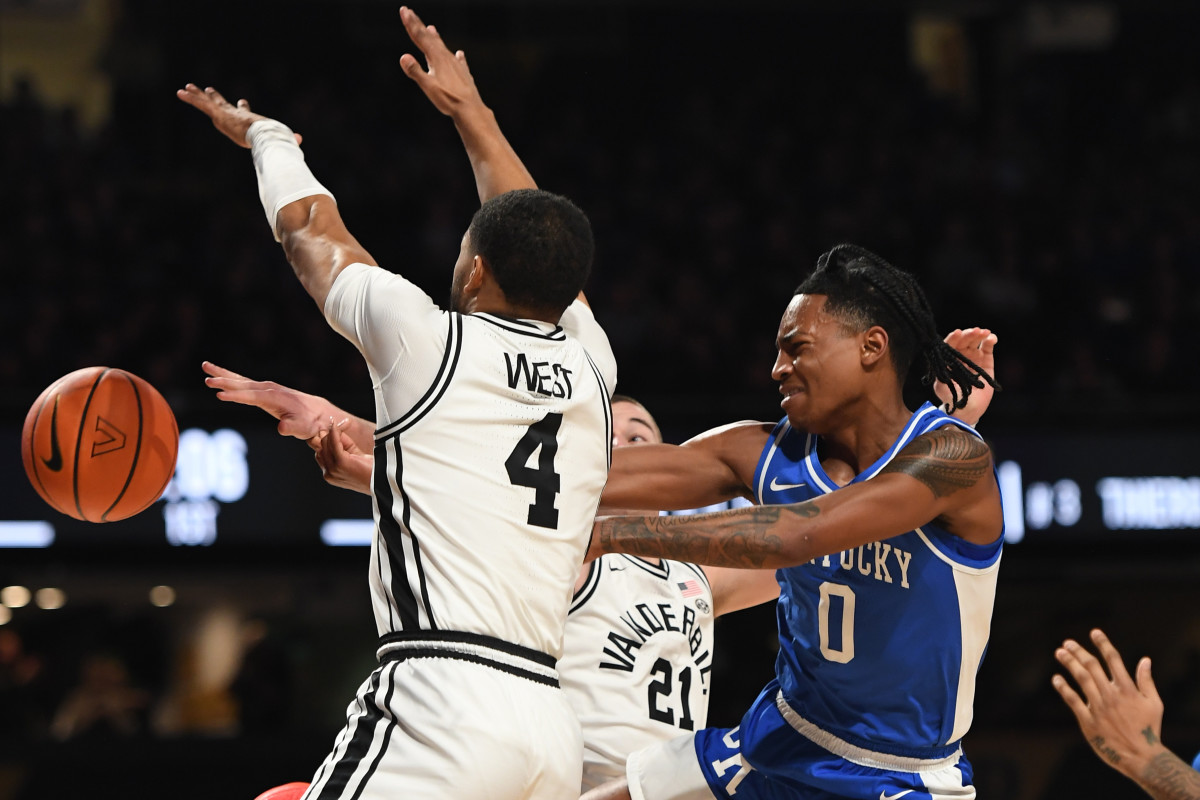 Feb 6, 2024; Nashville, Tennessee, USA; Kentucky Wildcats guard Rob Dillingham (0) loses the ball in the lane as he is defended by Vanderbilt Commodores guard Isaiah West (4) during the first half at Memorial Gymnasium. Mandatory Credit: Christopher Hanewinckel-USA TODAY Sports