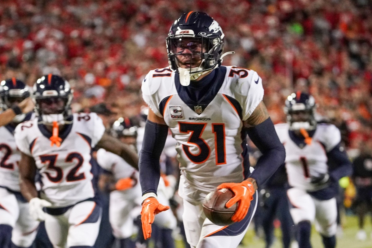 Oct 12, 2023; Kansas City, Missouri, USA; Denver Broncos safety Justin Simmons (31) celebrates after making an interception against the Kansas City Chiefs during the first half at GEHA Field at Arrowhead Stadium.