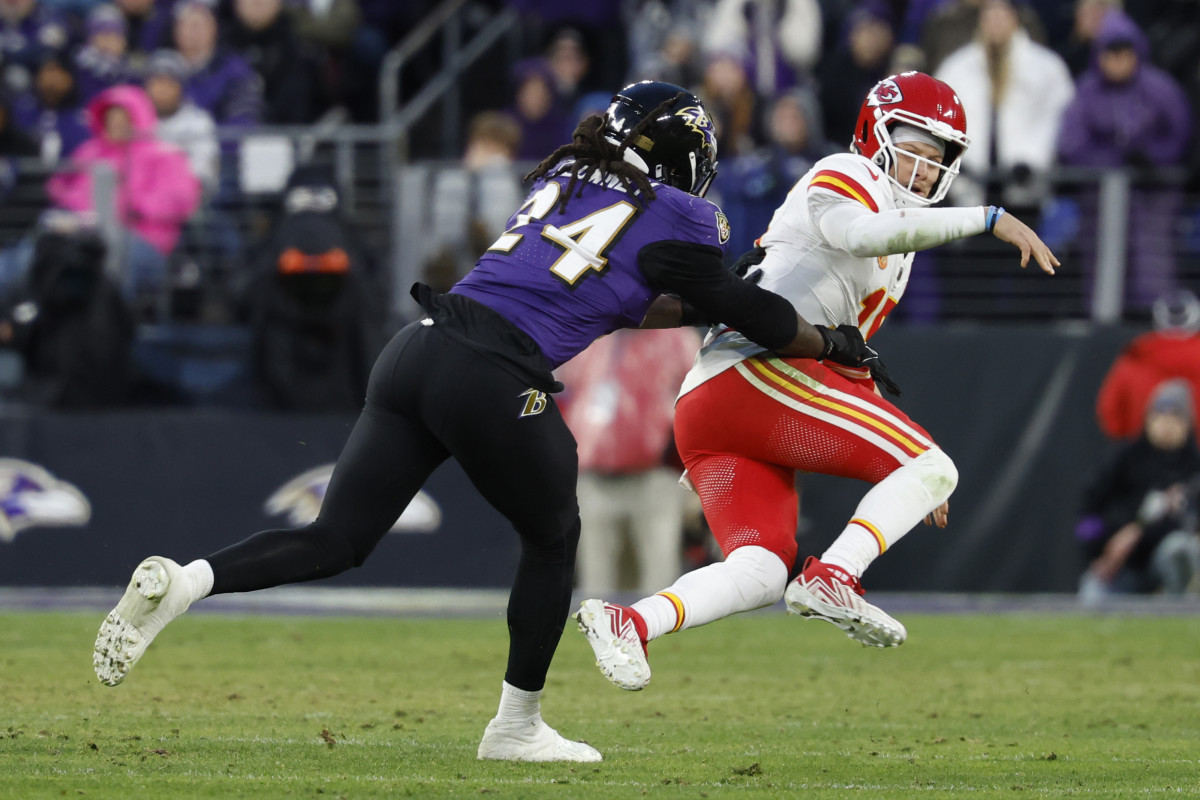 Jan 28, 2024; Baltimore, Maryland, USA; Kansas City Chiefs quarterback Patrick Mahomes (15) is knocked down after passing the ball by Baltimore Ravens linebacker Jadeveon Clowney (24) in the AFC Championship football game at M&T Bank Stadium. 