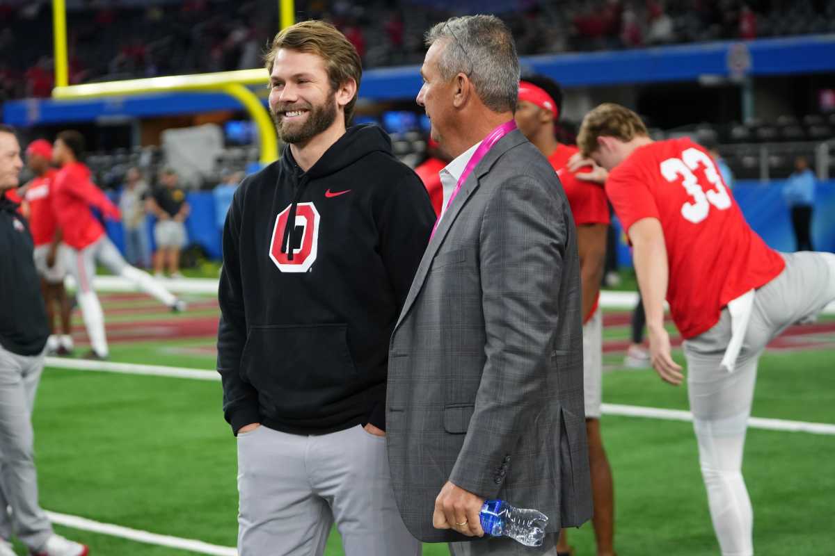 Dec 29, 2023; Arlington, Texas, USA; Ohio State Buckeyes quarterbacks coach Corey Dennis talks to his father in law, Urban Meyer, prior to the Goodyear Cotton Bowl Classic against the Missouri Tigers at AT&T Stadium.