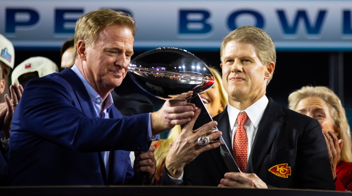 NFL commissioner Roger Goodell (left) hands Kansas City Chiefs owner Clark Hunt the Vince Lombardi Trophy after winning Super Bowl LVII against the Philadelphia Eagles.