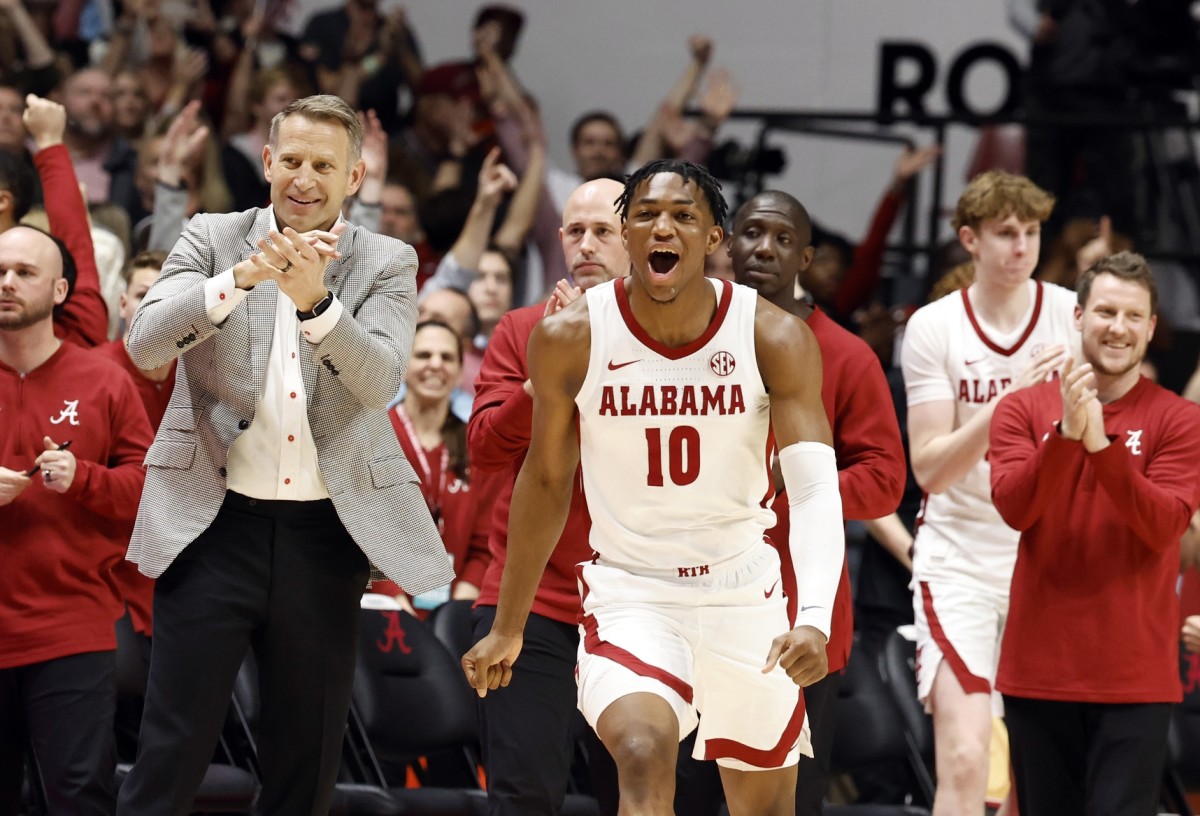 Alabama Crimson Tide head coach Nate Oats and forward Mouhamed Dioubate react after beating the Auburn Tigers.