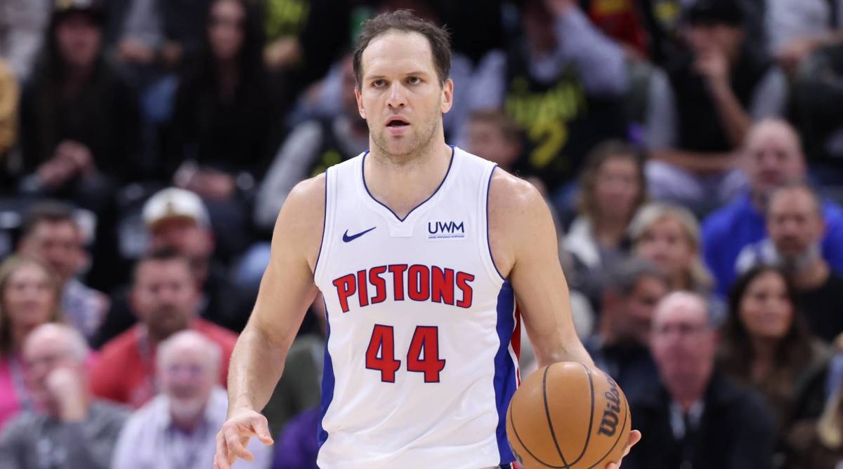 Pistons veteran Bojan Bogdanović dribbles the ball up the court in a game.