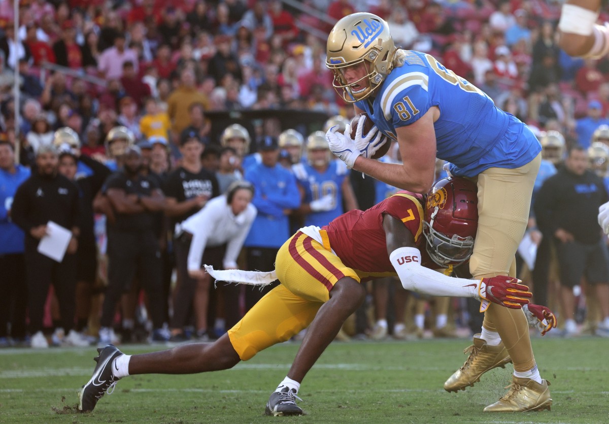 Nov 18, 2023; Los Angeles, California, USA; UCLA Bruins tight end Hudson Habermehl (81) scores a touchdown against USC Trojans safety Calen Bullock (7) during the fourth quarter at United Airlines Field at Los Angeles Memorial Coliseum.