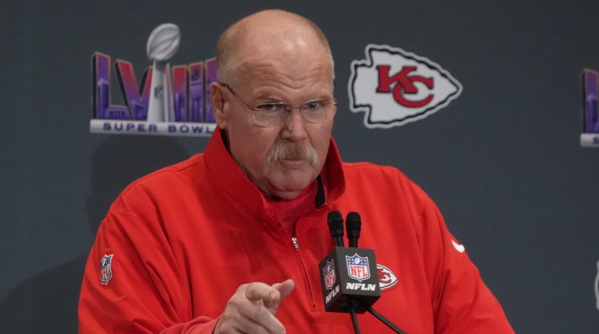Chiefs coach Andy Reid talks on a podium at a Super Bowl LVIII press conference