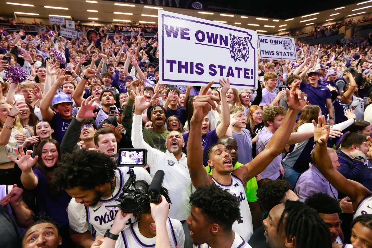 Kansas State coach Jerome Tang joins players with the student section after defeating Kansas 70-75 in overtime to claim the Sunflower Showdown inside Bramlage Coliseum on Feb. 5, 2024.
