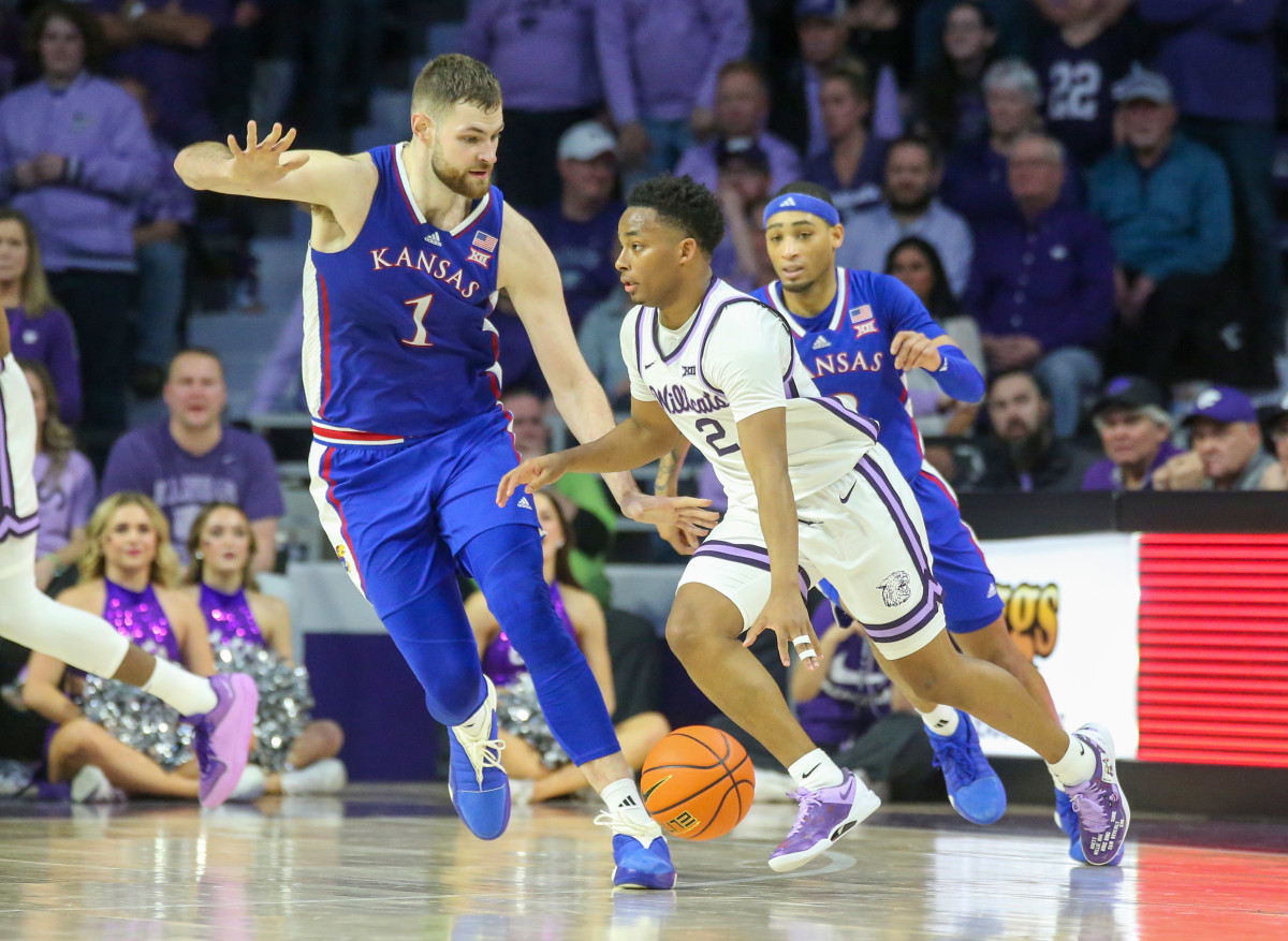 Kansas State Wildcats guard Tylor Perry dribbles against Kansas Jayhawks center Hunter Dickinson.
