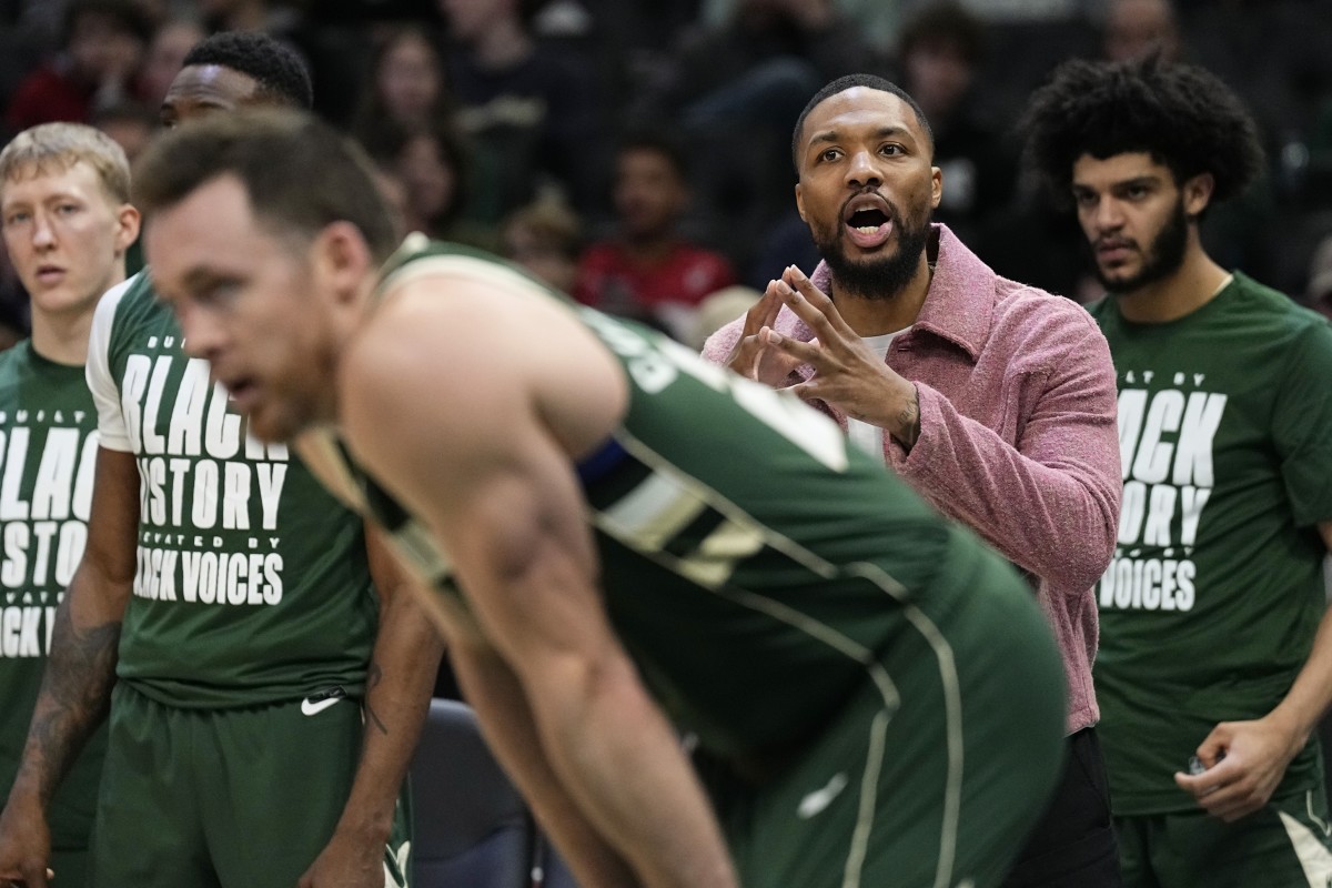 Milwaukee Bucks guard Damian Lillard calls out from the bench during the third quarter against the Minnesota Timberwolves 