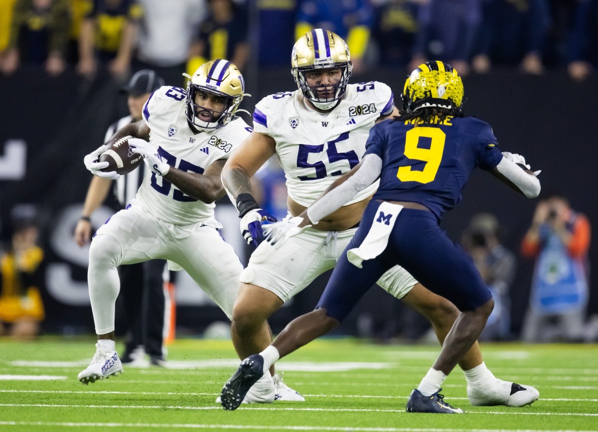 Jan 8, 2024; Houston, TX, USA; Washington Huskies offensive lineman Troy Fautanu (55) blocks for tight end Devin Culp (83) against the Michigan Wolverines during the 2024 College Football Playoff national championship game at NRG Stadium. Mandatory Credit: Mark J. Rebilas-USA TODAY Sports  