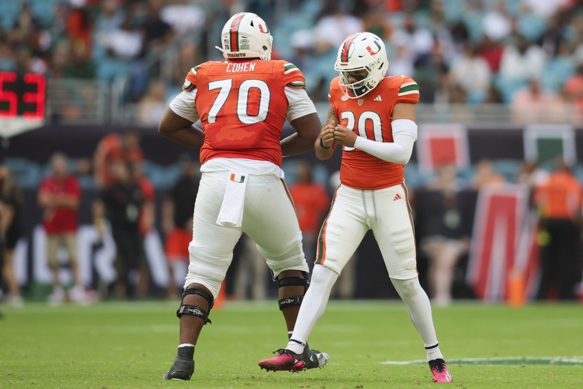 Nov 18, 2023; Miami Gardens, Florida, USA; Miami Hurricanes kicker Andres Borregales (30) celebrates with offensive lineman Javion Cohen (70) after scoring a game-tying field goal against the Louisville Cardinals during the fourth quarter at Hard Rock Stadium. Mandatory Credit: Sam Navarro-USA TODAY Sports  