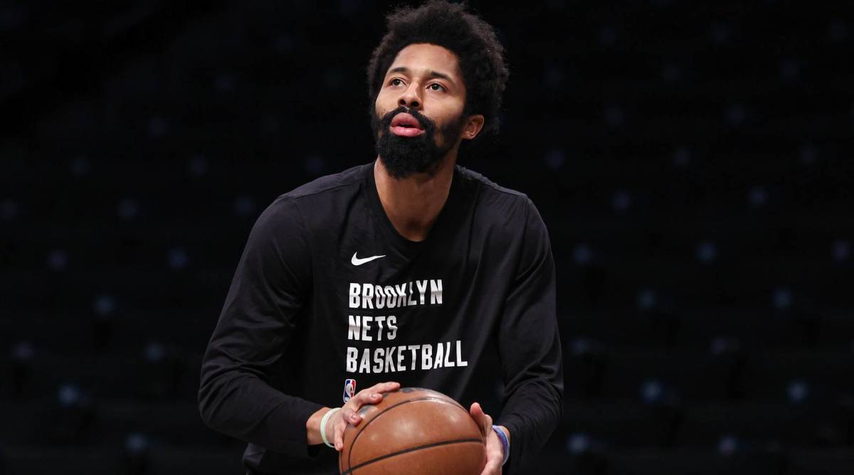Nets point guard shoots a ball during warmups before a game.