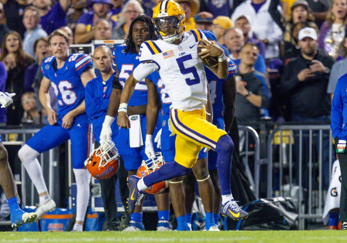 Nov 11, 2023; Baton Rouge, Louisiana, USA; LSU Tigers quarterback Jayden Daniels (5) rushes for a touchdown against the Florida Gators during the first half at Tiger Stadium.