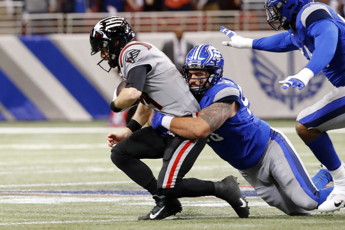 Feb 23, 2020; St. Louis, Missouri, USA; NY Guardians quarterback Matt McGloin (14) is sacked by St. Louis Battlehawks defensive tackle Casey Sayles (90) during the first half of an XFL game at The Dome at America's Center. Mandatory Credit: Billy Hurst-USA TODAY Sports