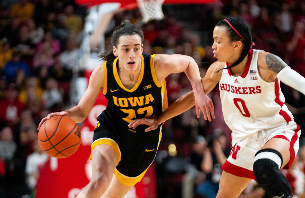 Iowa's Caitlin Clark dribbles the ball as Nebraska's Darian White defends during the first half Sunday at Pinnacle Bank Arena in Lincoln.