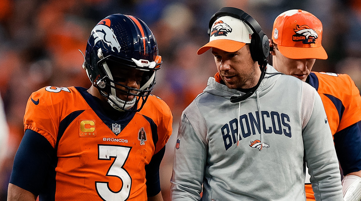 Denver Broncos quarterback Russell Wilson (3) talks with quarterbacks coach Klint Kubiak in the fourth quarter against the Los Angeles Chargers at Empower Field at Mile High.