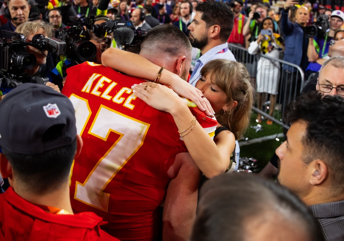 Travis Kelce and Taylor Swift embrace after Kelce's overtime win in Super Bowl LVIII.
