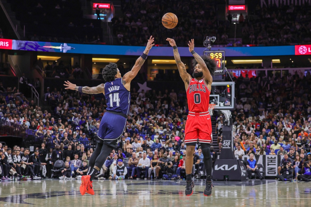 Chicago Bulls guard Coby White (0) shoots the ball over Orlando Magic guard Gary Harris (14) during the second half at KIA Center.