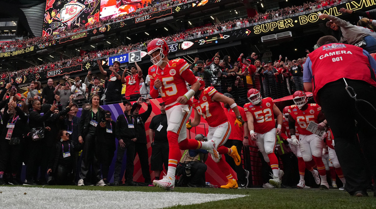 Patrick Mahomes runs out of the tunnel leading his team behind him