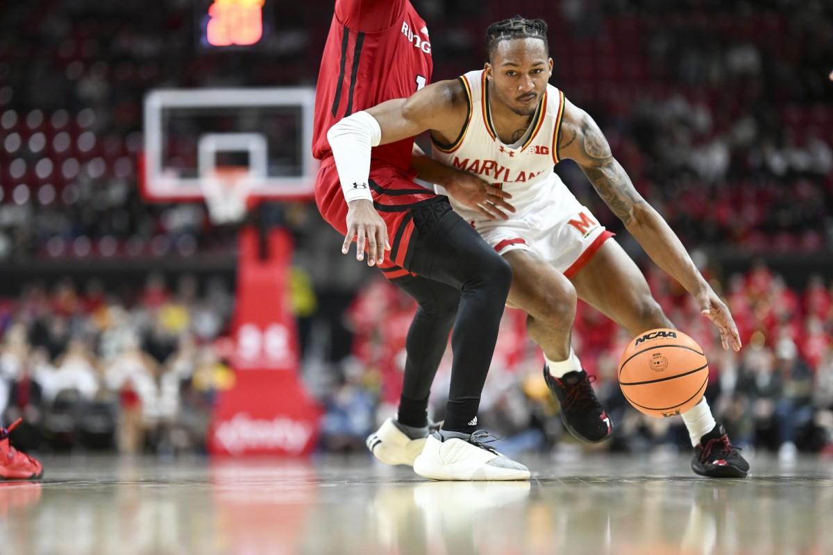 Maryland Terrapins guard Jahmir Young dribbles past Rutgers Scarlet Knights guard Jamichael Davis during the second half at Xfinity Center in College Park, Md., on Feb. 6, 2024.