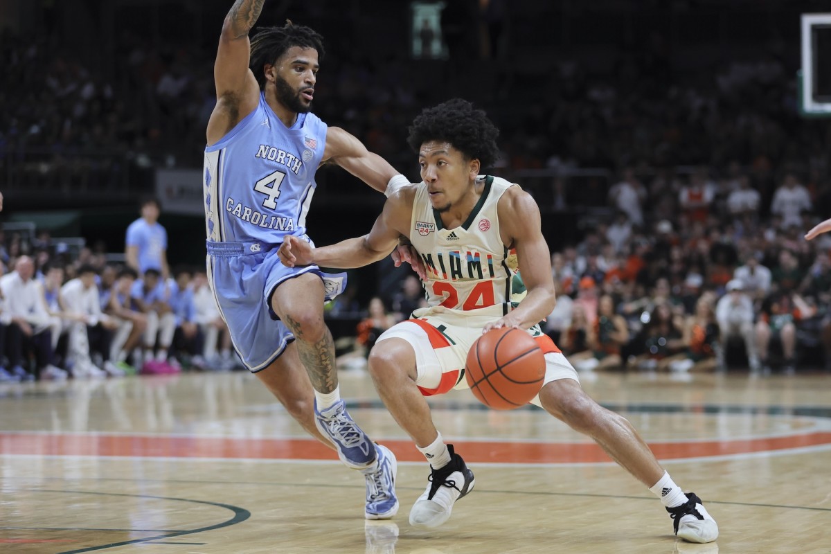 Miami Hurricanes guard Nijel Pack (24) drives to the basket past North Carolina Tar Heels guard RJ Davis (4) during the second half at Watsco Center in Coral Gables, Fla., on Feb. 10, 2024.