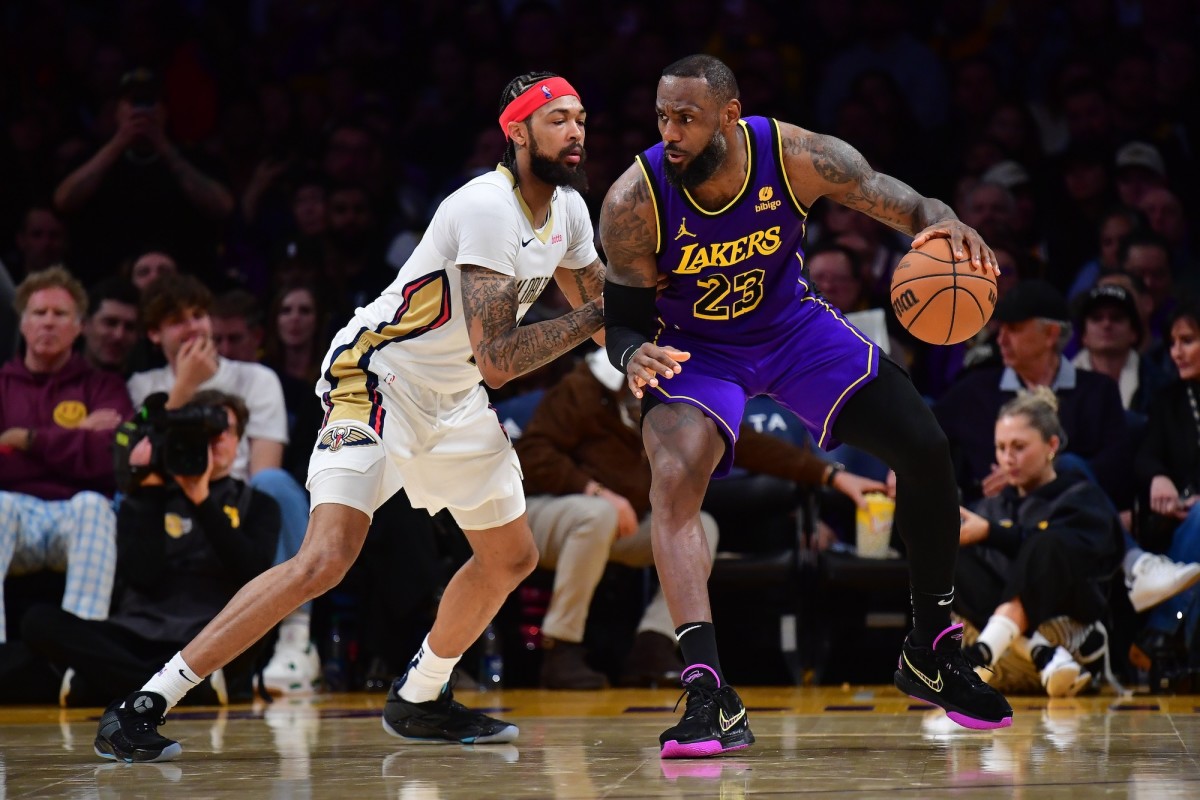 Los Angeles Lakers forward LeBron James moves the ball against New Orleans Pelicans forward Brandon Ingram during the second half at Crypto.com Arena in Los Angeles on Feb. 9, 2024.