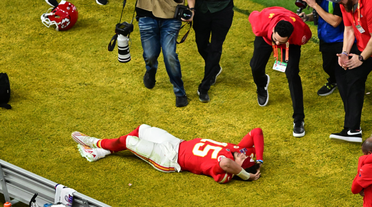 Patrick Mahomes lays on the turf with his hands on his head
