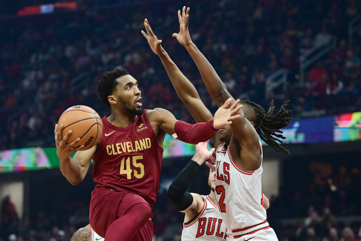 Feb 14, 2024; Cleveland, Ohio, USA; Cleveland Cavaliers guard Donovan Mitchell (45) drives to the basket against Chicago Bulls guard Ayo Dosunmu (12) during the first half at Rocket Mortgage FieldHouse.