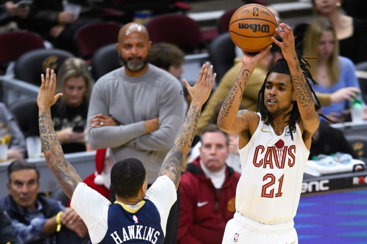 Dec 21, 2023; Cleveland, Ohio, USA; Cleveland Cavaliers forward Emoni Bates (21) shoots as New Orleans Pelicans guard Jordan Hawkins (24) defends in the fourth quarter at Rocket Mortgage FieldHouse.