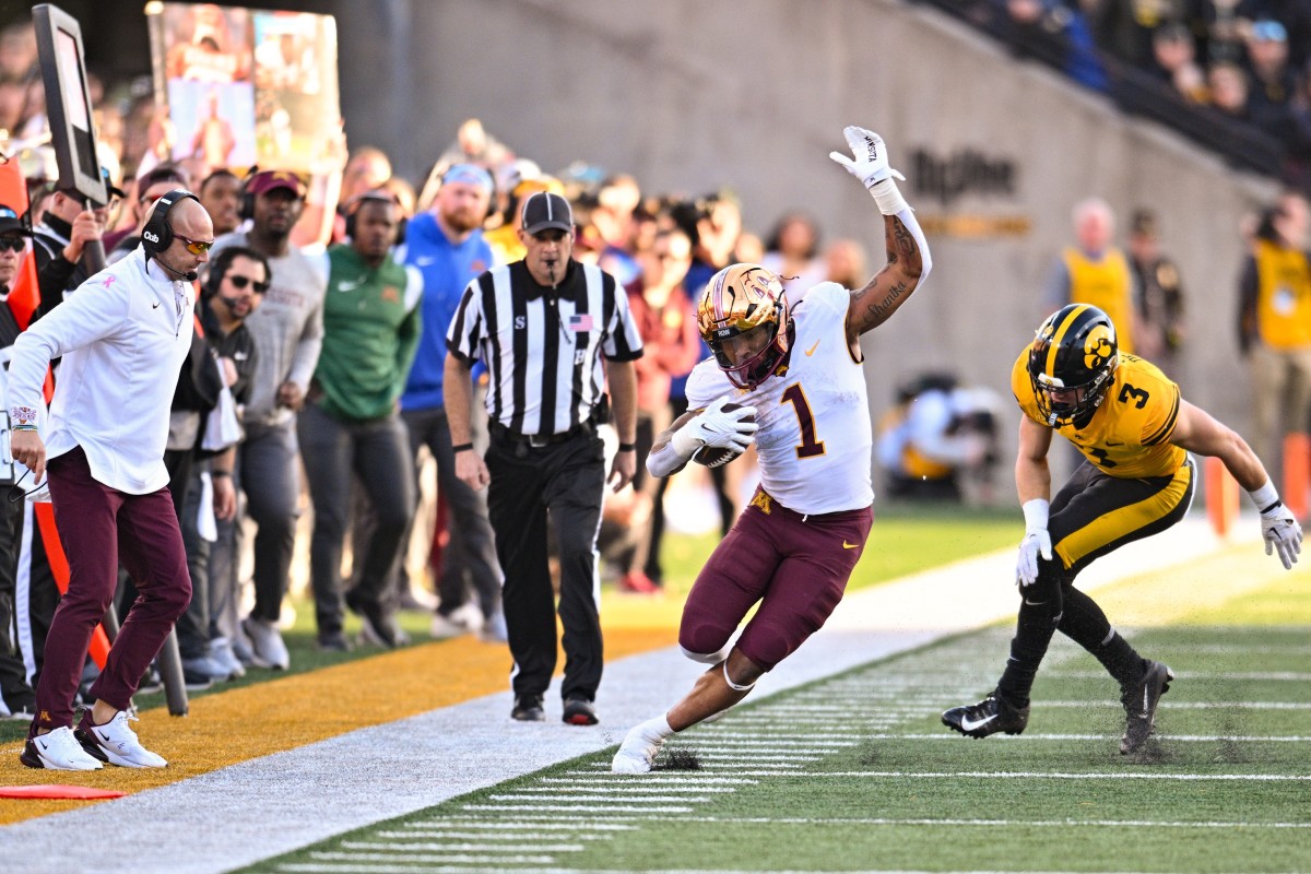 Oct 21, 2023; Iowa City, Iowa, USA; Minnesota Golden Gophers running back Darius Taylor (1) stays in bounds after the catch as Iowa Hawkeyes defensive back Cooper DeJean (3) chases and head coach P.J. Fleck (left) looks on during the third quarter at Kinnick Stadium.