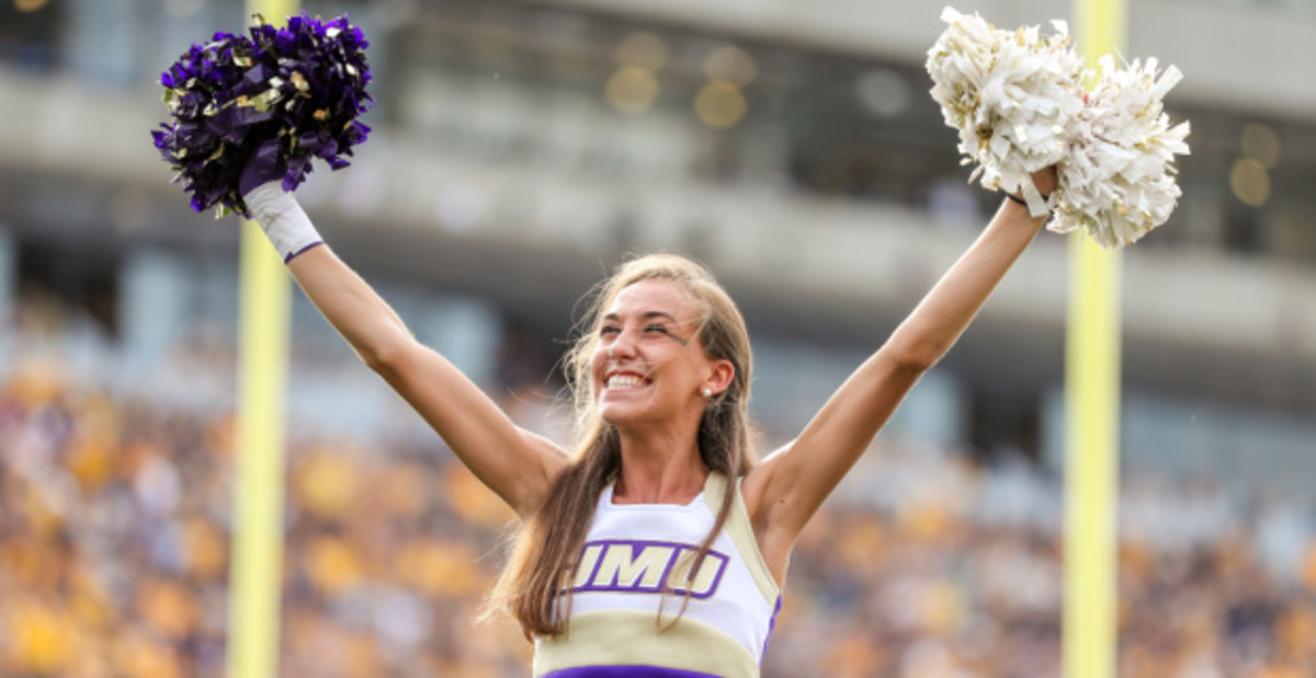 A cheerleader peps up the crowd at a James Madison game during the college football season.