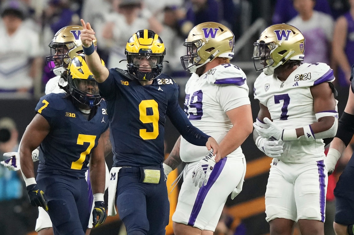 Michigan quarterback J.J. McCarthy points down the field during the second half of the College Football Playoff national championship game against Washington at NRG Stadium in Houston, Texas on Monday, Jan. 8, 2024.