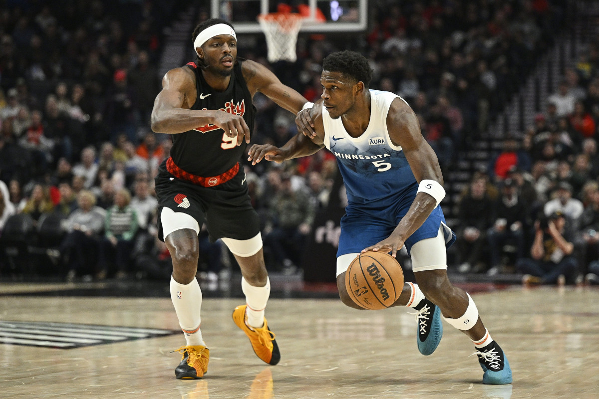Feb 15, 2024; Portland, Oregon, USA; Minnesota Timberwolves guard Anthony Edwards (5) drives to the basket during the first half against Portland Trail Blazers forward Jerami Grant (9) at Moda Center.