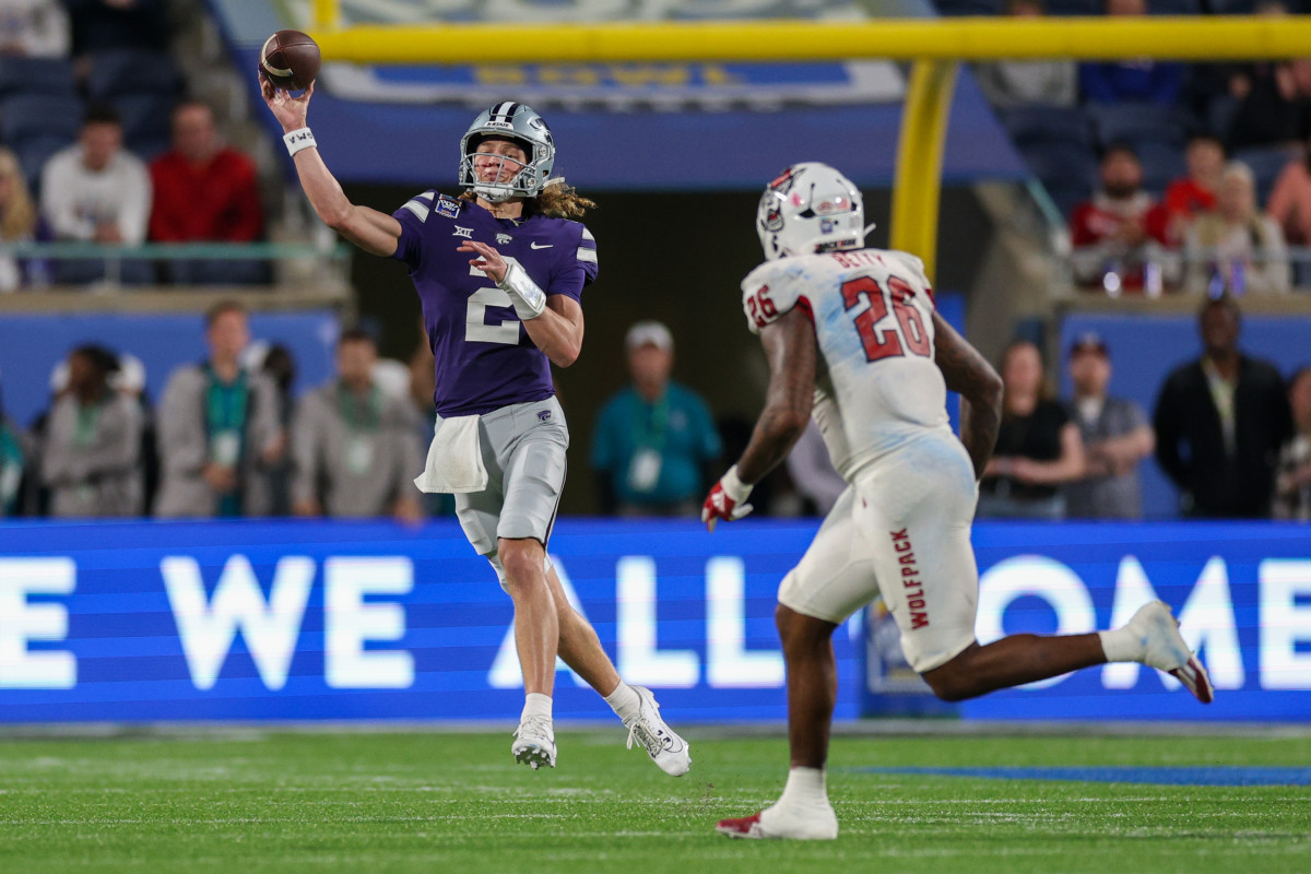 Dec 28, 2023; Orlando, FL, USA; Kansas State Wildcats quarterback Avery Johnson (2) throws a pass guarded by North Carolina State Wolfpack linebacker Devon Betty (26) in the fourth quarter during the Pop-Tarts bowl at Camping World Stadium. Mandatory Credit: Nathan Ray Seebeck-USA TODAY Sports