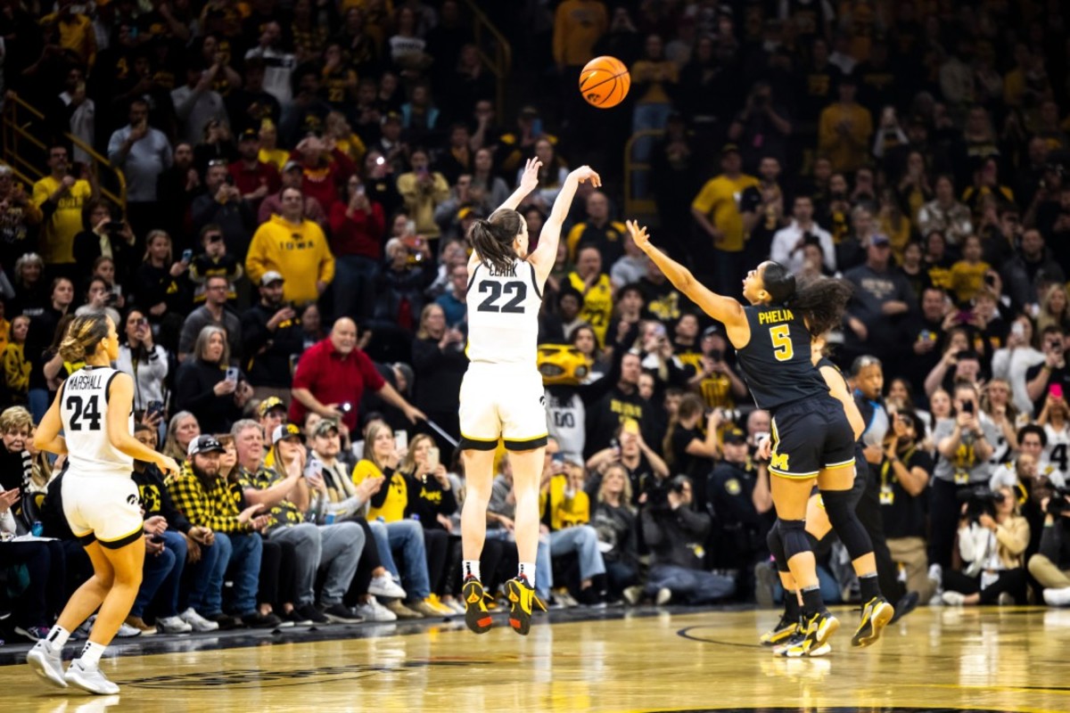 Iowa guard Caitlin Clark (22) makes a 3-point basket setting the record for all-time leading scoring during a NCAA Big Ten Conference women's basketball game against Michigan, Thursday, Feb. 15, 2024, at Carver-Hawkeye Arena in Iowa City, Iowa.