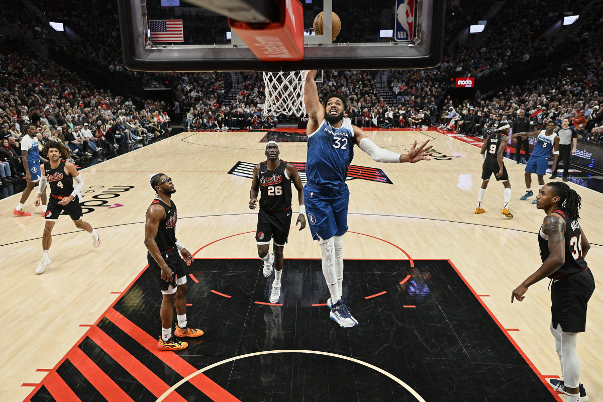 Feb 15, 2024; Portland, Oregon, USA; Minnesota Timberwolves center Karl-Anthony Towns (32) dunks the basketball during the second half against Portland Trail Blazers center Duop Reath (26) at Moda Center.