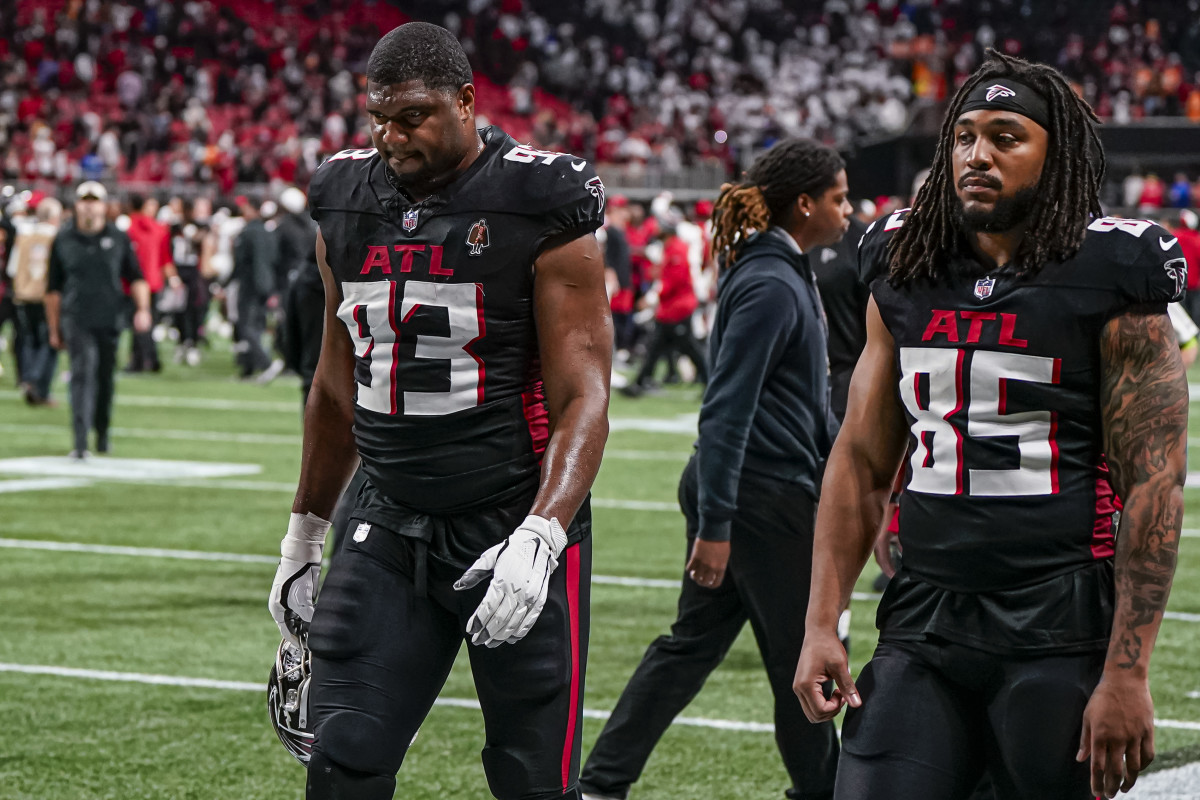 Dec 10, 2023; Atlanta, Georgia, USA; Atlanta Falcons defensive tackle Calais Campbell (93) and tight end MyCole Pruitt (85) leave the field after being defeated by the Tampa Bay Buccaneers at Mercedes-Benz Stadium. 