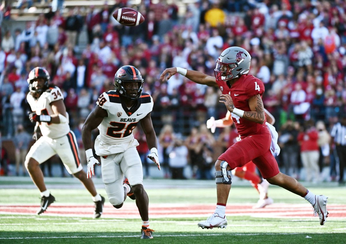 Oregon State Beavers defensive back Kitan Oladapo (28) pressures Washington State Cougars quarterback Jayden de Laura (4).