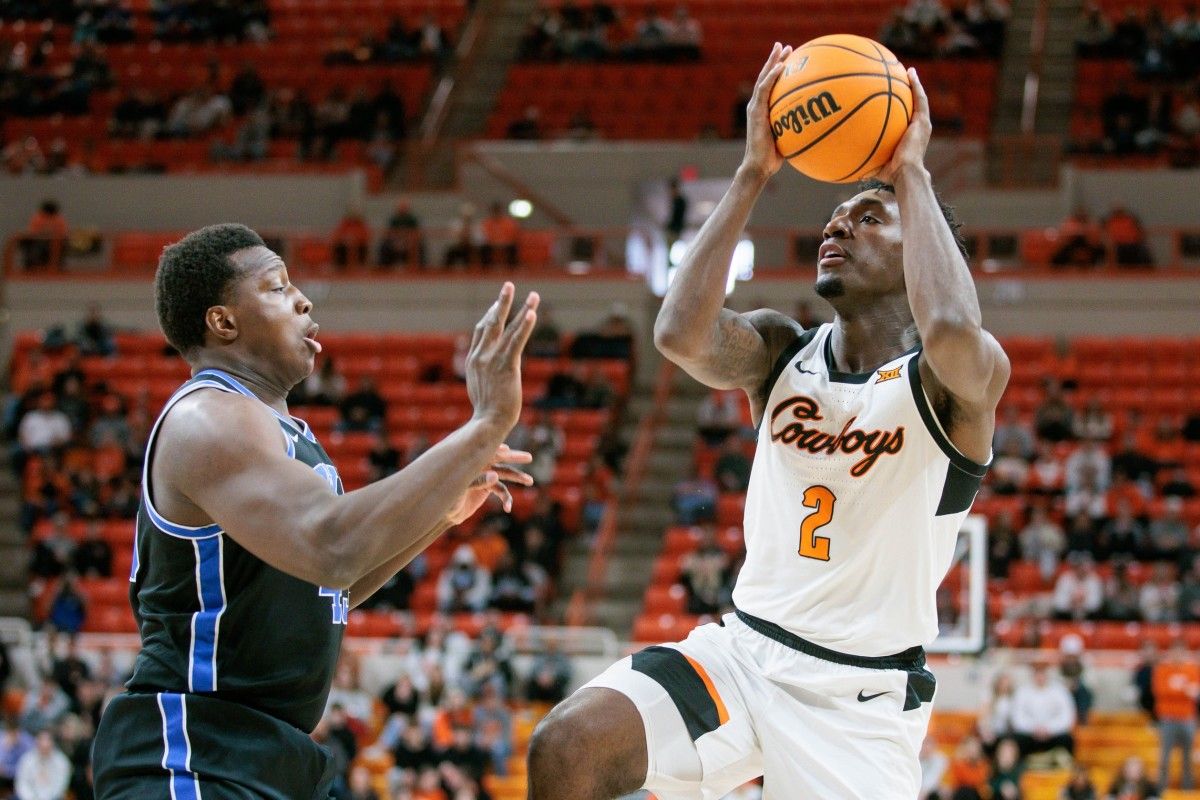 Oklahoma State Cowboys forward Eric Dailey Jr. (2) shoots the ball over Brigham Young Cougars forward Fousseyni Traore (45) during the first half at Gallagher-Iba Arena.